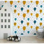 Air balloons wallpaper in playroom with house-shaped room divider and toy car, yellow and teal pattern