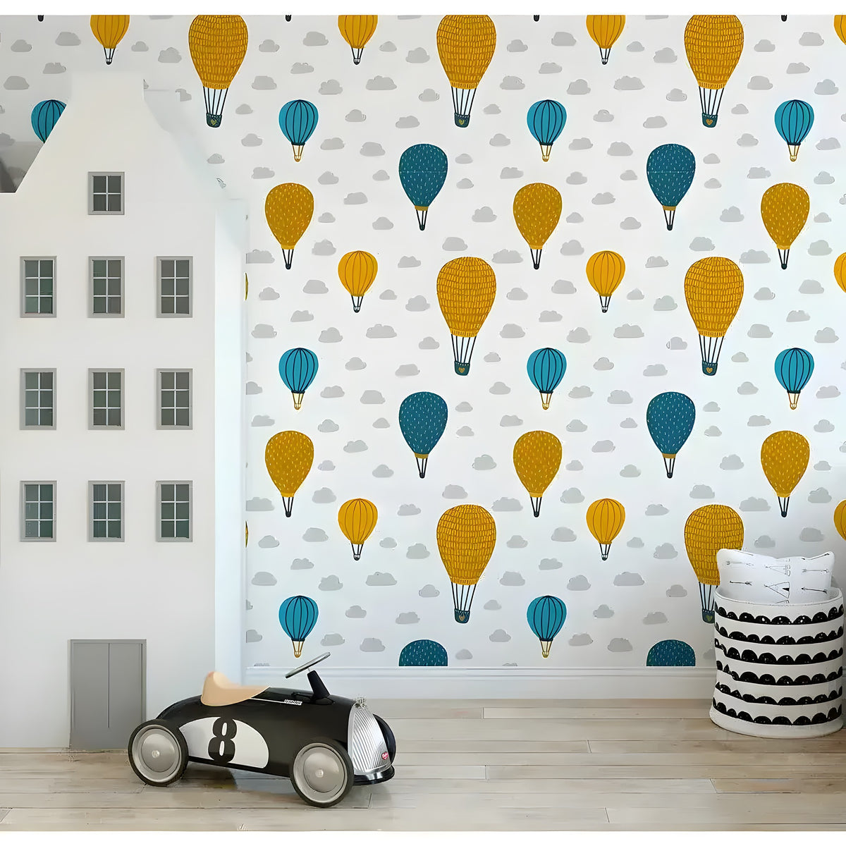 Air balloons wallpaper in playroom with house-shaped room divider and toy car, yellow and teal pattern