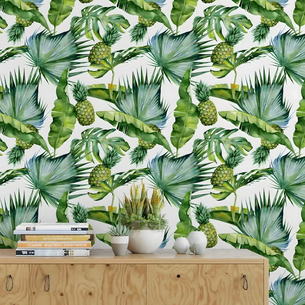 Plywood sideboard with succulents below tropical palm leaves and pineapples removable wallpaper