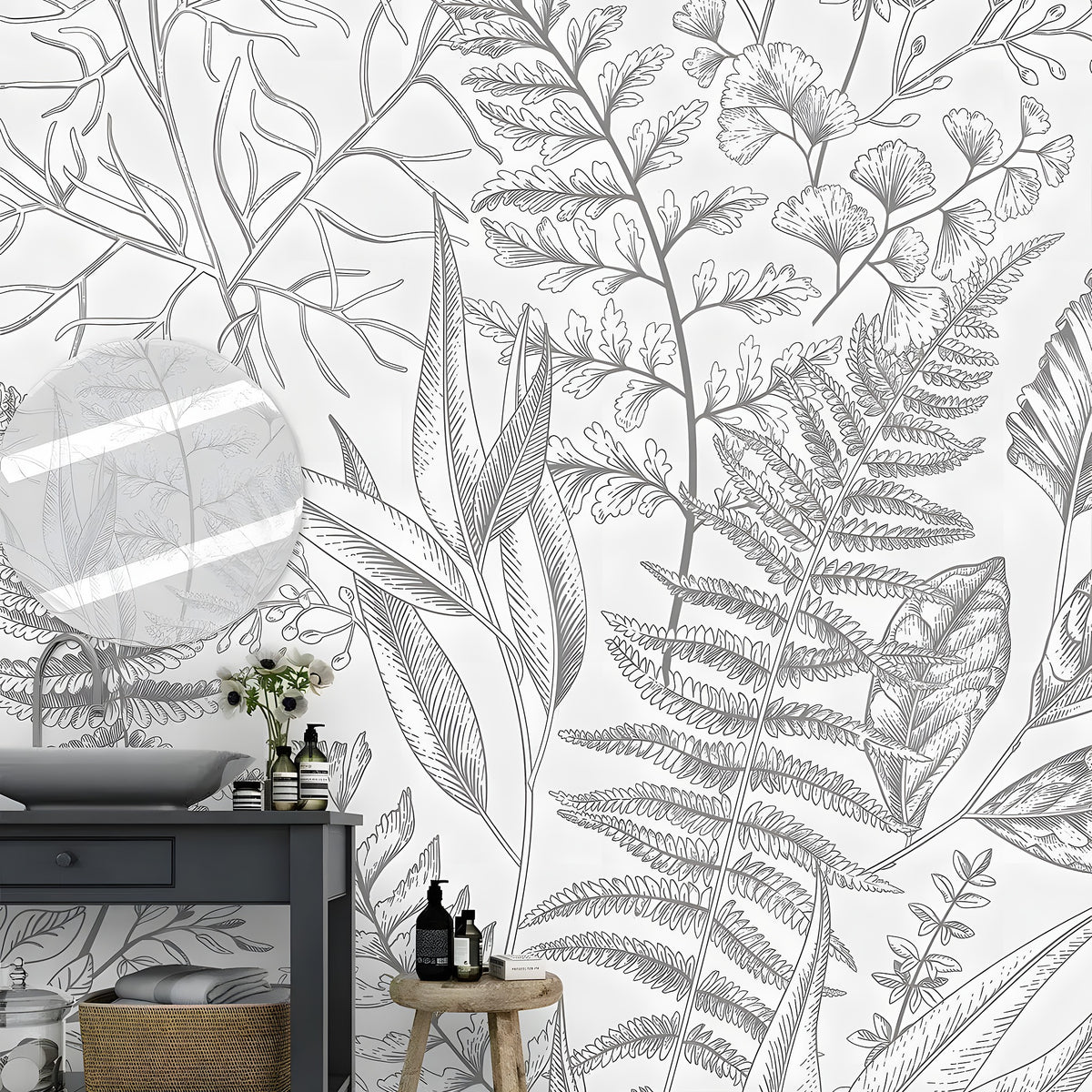 Gray fern botanical wall mural in a bathroom with dark vanity, round mirror, and wooden stool