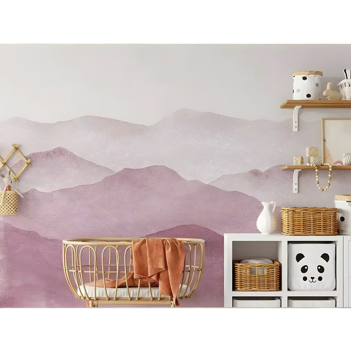 Pink watercolor abstract mountains mural in a nursery, layered dusky rose mountain silhouettes fading to pale blush at top