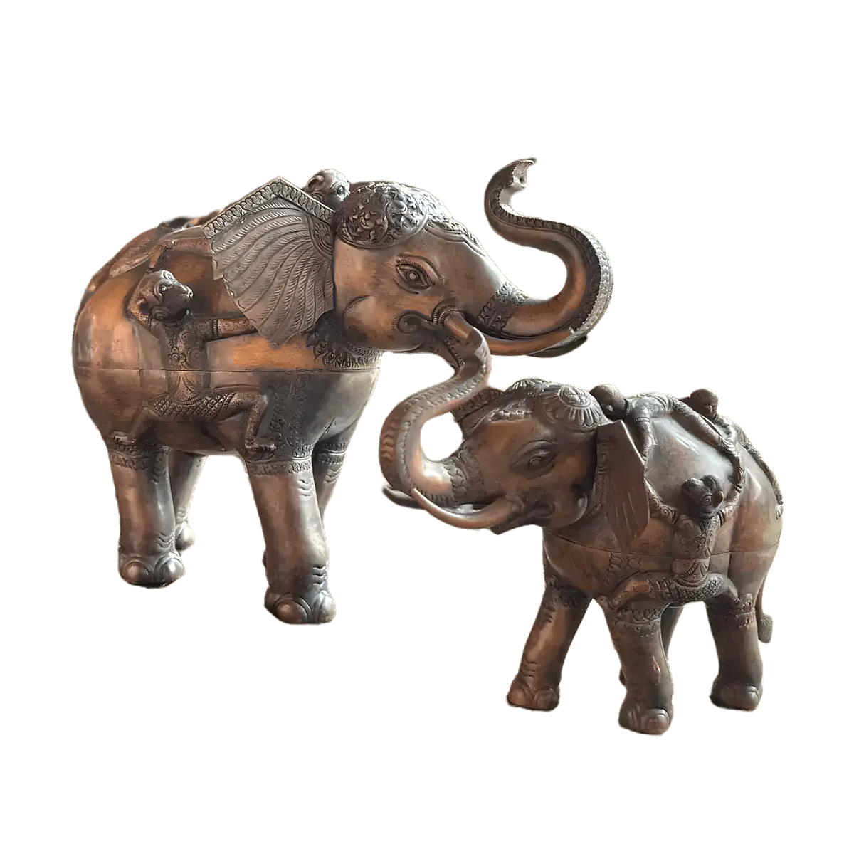 Two solid brass elephant betel storage boxes with raised trunks and engraved decorative detail