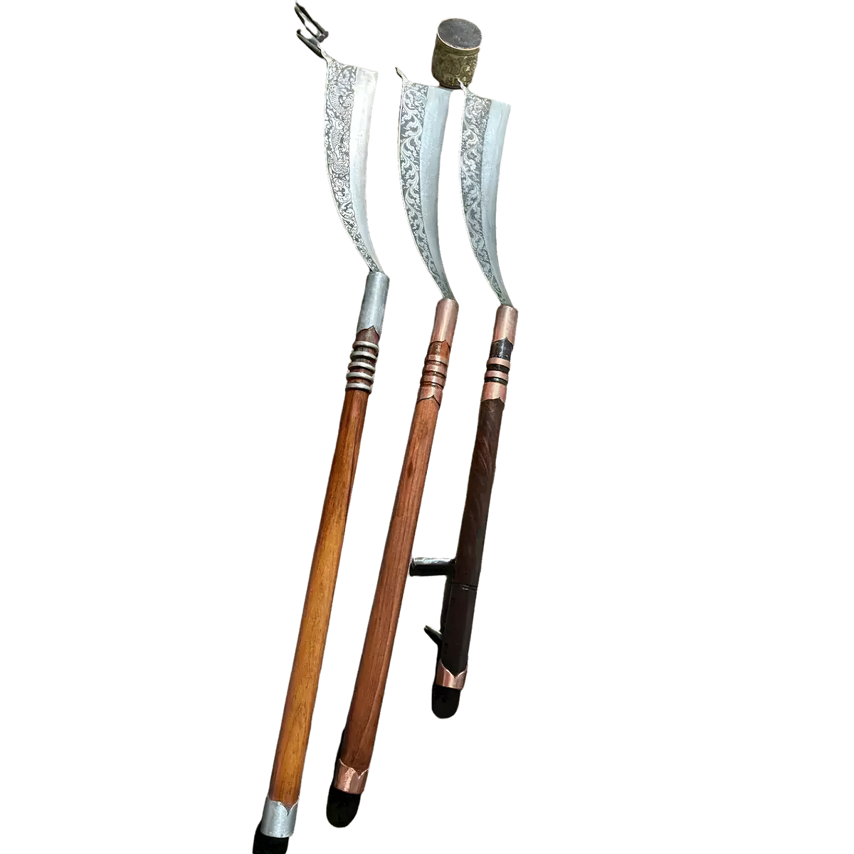 Three hand-engraved Khmer machete knives with long wooden handles displayed vertically together