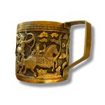 Brass mug with handle showing warriors-and-horse scene — archer and horseman relief, dark niello, rectangular handle