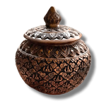 Round brass niello betel box, front view, dense gold-and-black floral scrollwork, lotus bud finial on domed lid