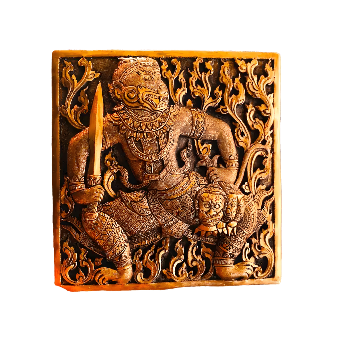 Close-up of engraved brass betel box lid with Hanuman warrior figure holding sword amid floral scrollwork