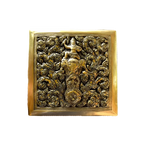 Top view of small square brass betel box with deep elephant and deity motif amid gold floral scrollwork