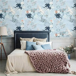 Bedroom with Paradise of Blue Chinoiserie wallpaper; sky-blue background with white cranes, navy botanicals, and pink blooms