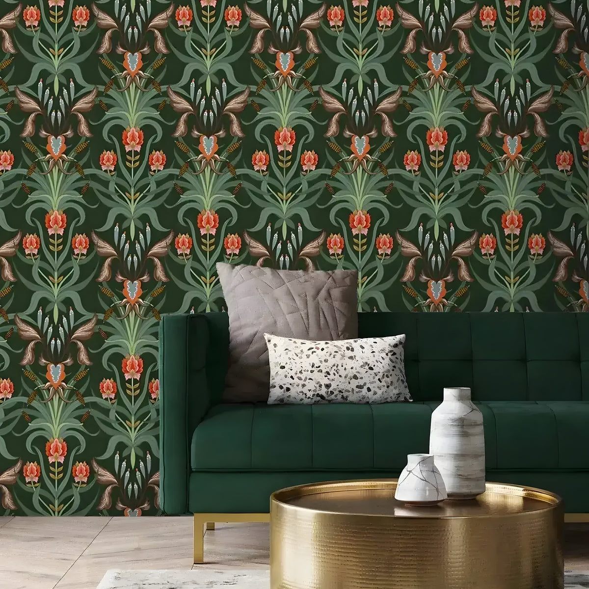 Alaia vintage dark botanical wallpaper installed in a living room with emerald sofa, pillows, and gold round coffee table