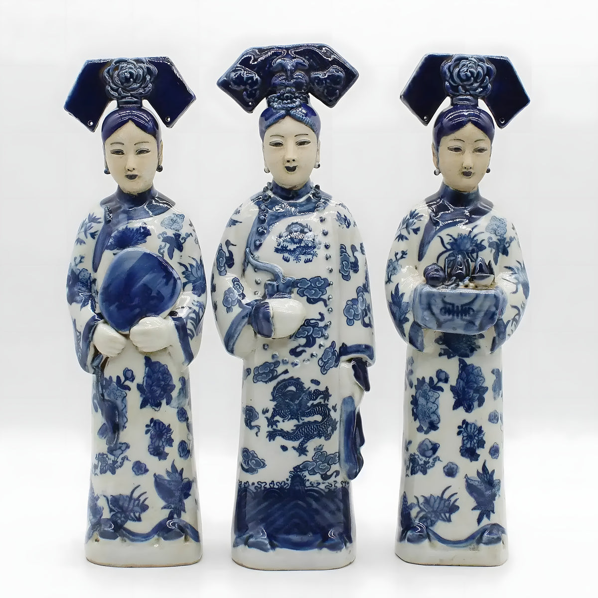 Three hand-painted Qing Dynasty princess figurines: one with fan, one with vase, one bearing offering tray
