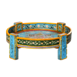 Hand-carved wooden chakki table — turquoise gold Rajasthani paint, floral vine apron, lotus motif on top, block legs