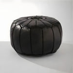Black genuine leather round floral pouf ottoman — front view with hand-stitched petal segments, white background
