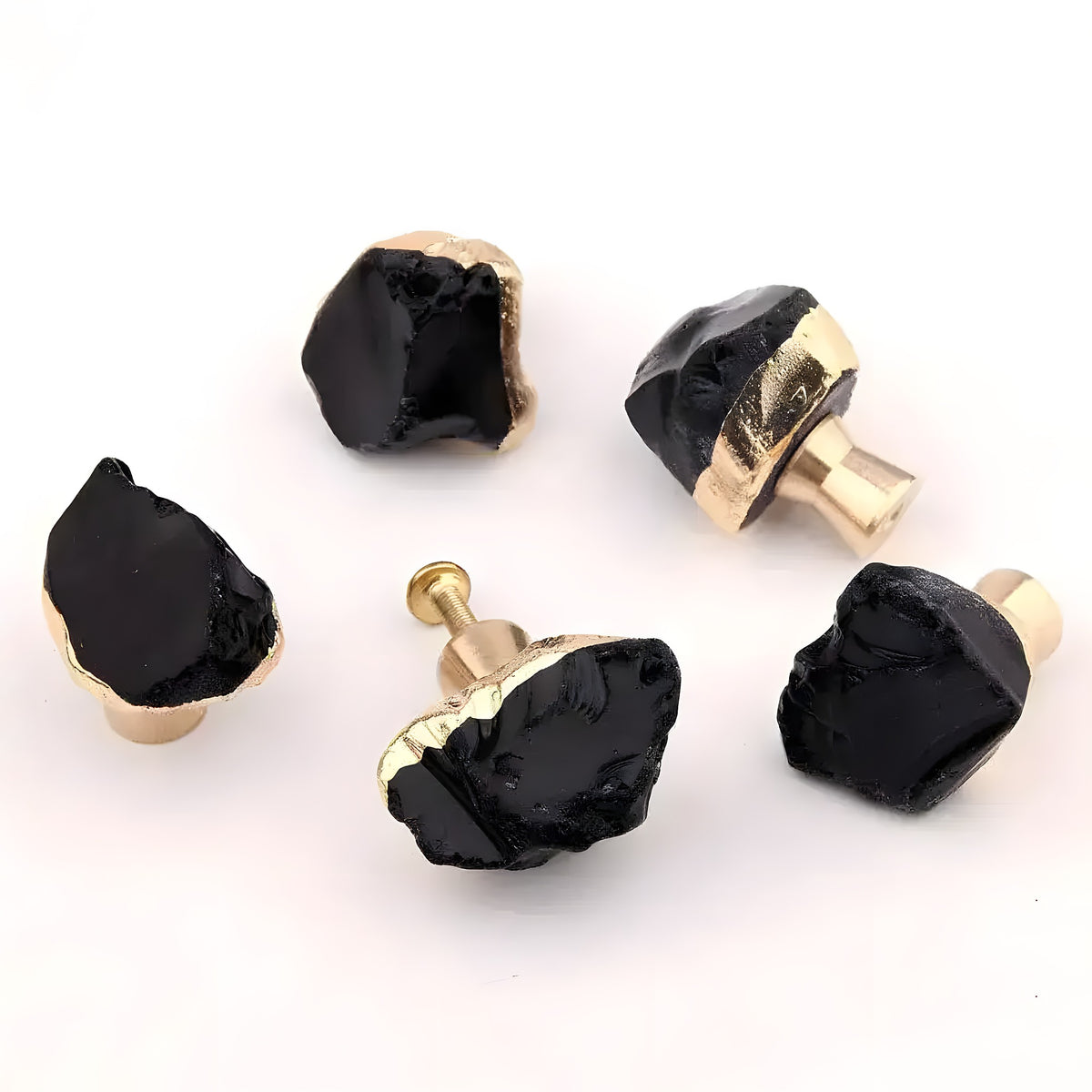 Five black obsidian crystal cabinet knobs with gold bases shown from multiple angles on white background