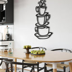 Three black stacked coffee cups with steam outline on white wall in modern kitchen dining area