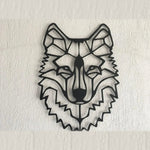 Black geometric wolf head metal wall hanging, angular front view on white textured wall