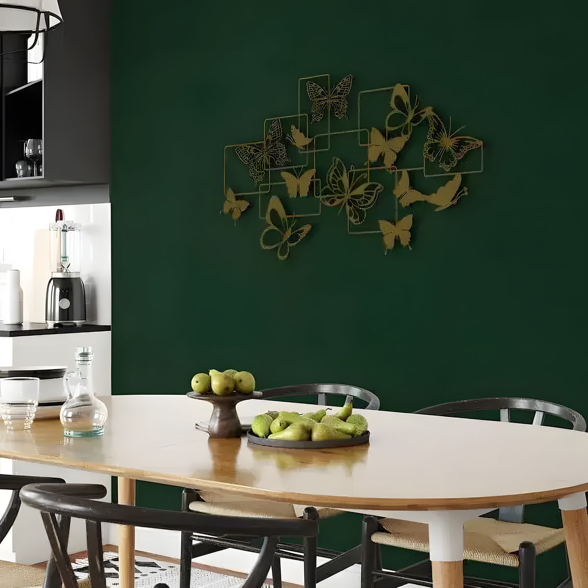 Gold flock of butterflies wall art with overlapping square frames on dark green kitchen wall above dining table