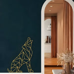 Gold geometric wolf in howling seated pose on dark navy wall beside white arch doorway