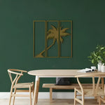Gold Palm Tree 3 Panels metal wall art, three framed panels with leaning palm silhouette on dark green wall above dining table