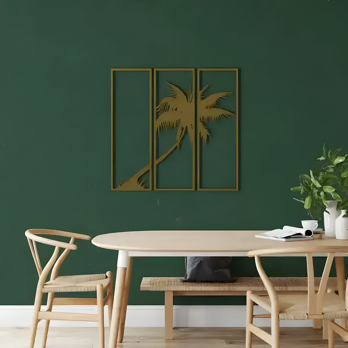 Gold Palm Tree 3 Panels metal wall art, three framed panels with leaning palm silhouette on dark green wall above dining table