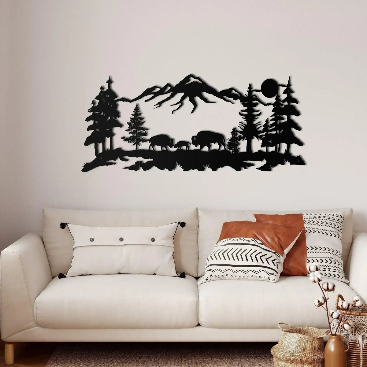 Bison and Mountain Metal Wall Hangings black panoramic scene on white wall above cream boho sofa