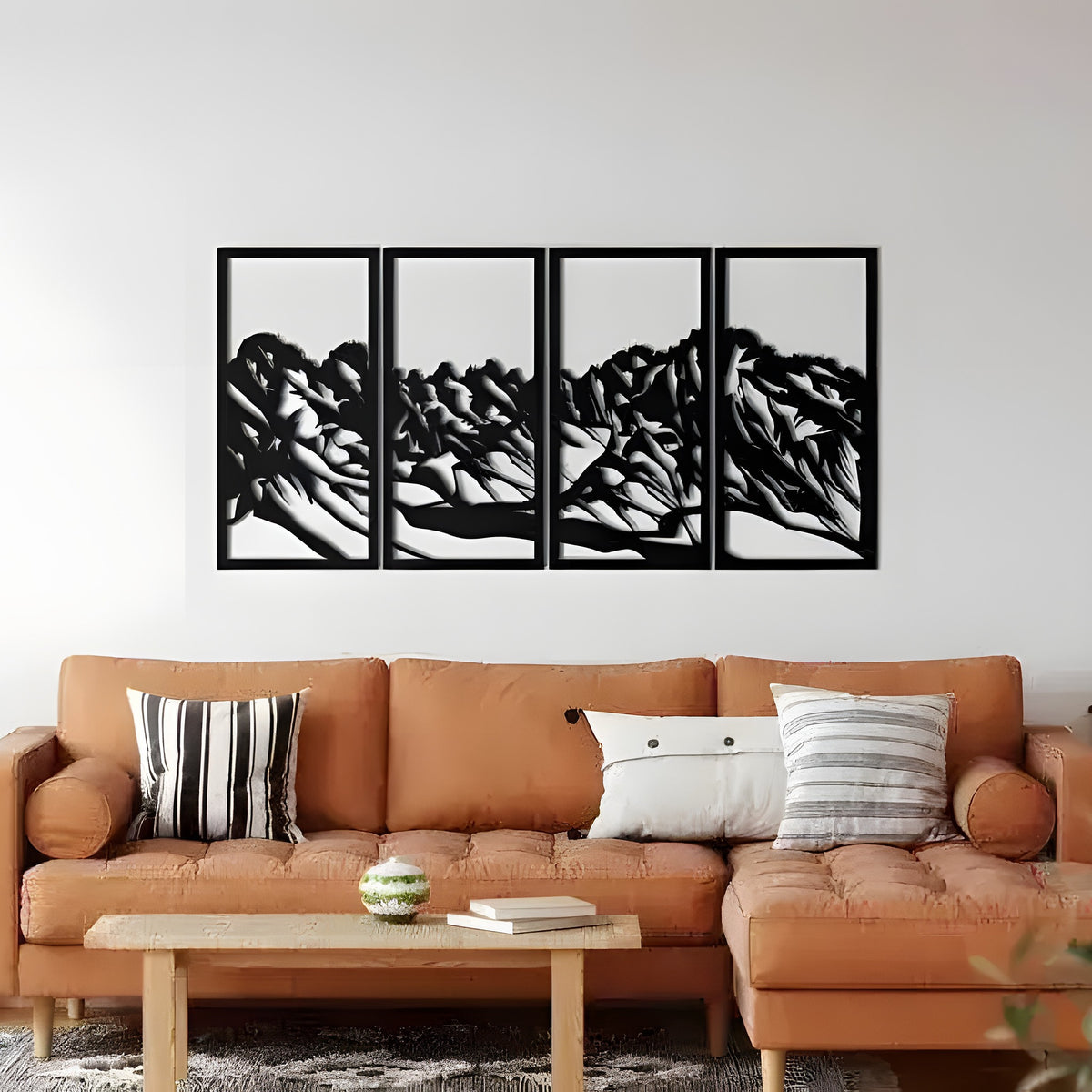 Black 4-panel mountain landscape wall hangings in boho living room, tan leather sofa, white wall, plants