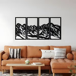 Black 4-panel mountain landscape wall hangings in boho living room, tan leather sofa, white wall, plants