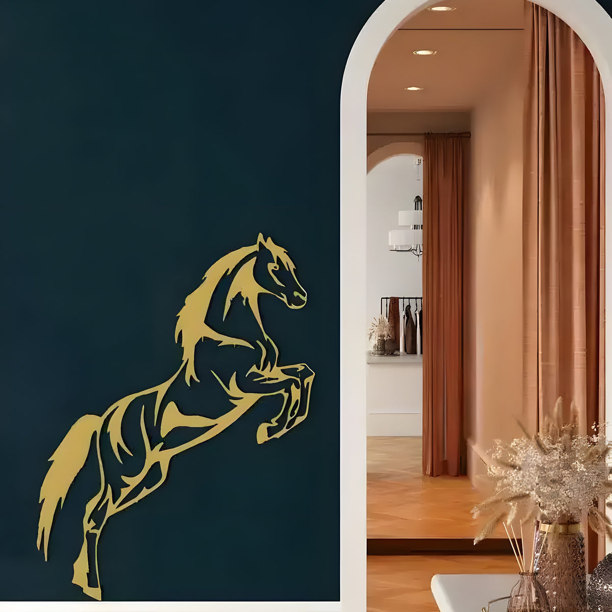 Gold jumping horse metal wall art on dark navy wall beside white arch, dried floral vase below