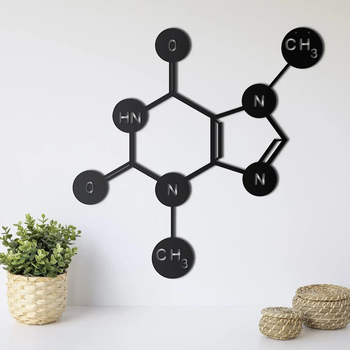 Chocolate Symbol Theobromine Molecule metal wall decor in black, structural formula with atomic nodes, displayed on white wall