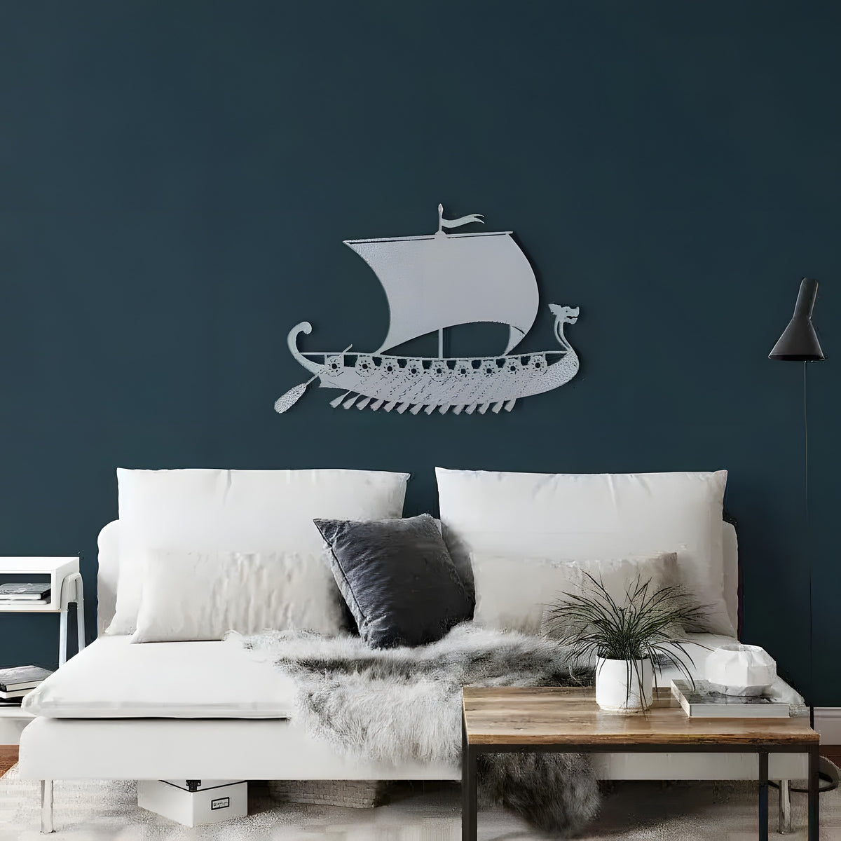 Silver Pirate Ship metal wall decor, Viking longship with dragon prow and oars on dark navy bedroom wall above white sofa