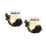 Two clear glass mugs filled with cream soy wax, each decorated with black agate crystal clusters and chips, front view