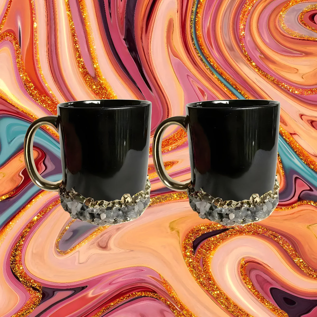 Set of two black ceramic mugs with gold handles and quartz crystal chip band at base, against a swirling marble backdrop