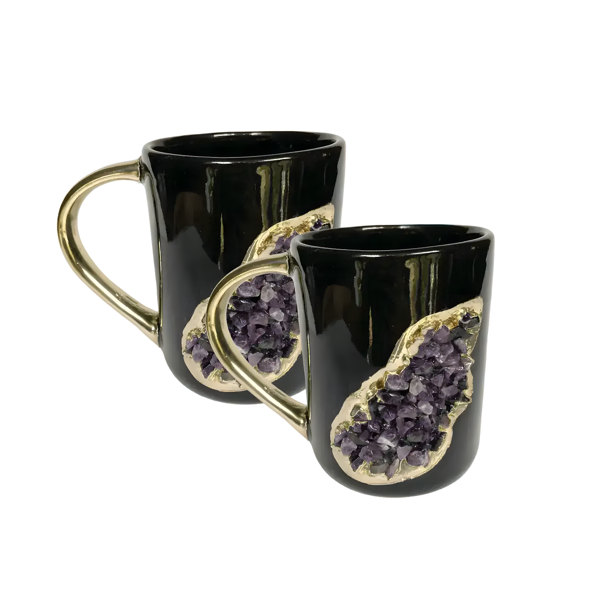 Two black ceramic mugs with gold handles and purple amethyst druzy inset with gold surround, stacked on white