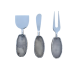 Three silver clear quartz agate cheese tools on light grey, oval grey-clear agate handles, silver jagged edges