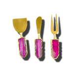 Three pink agate cheese knives with gold blades, vibrant magenta agate handles with gold-trimmed edges, front view on gray