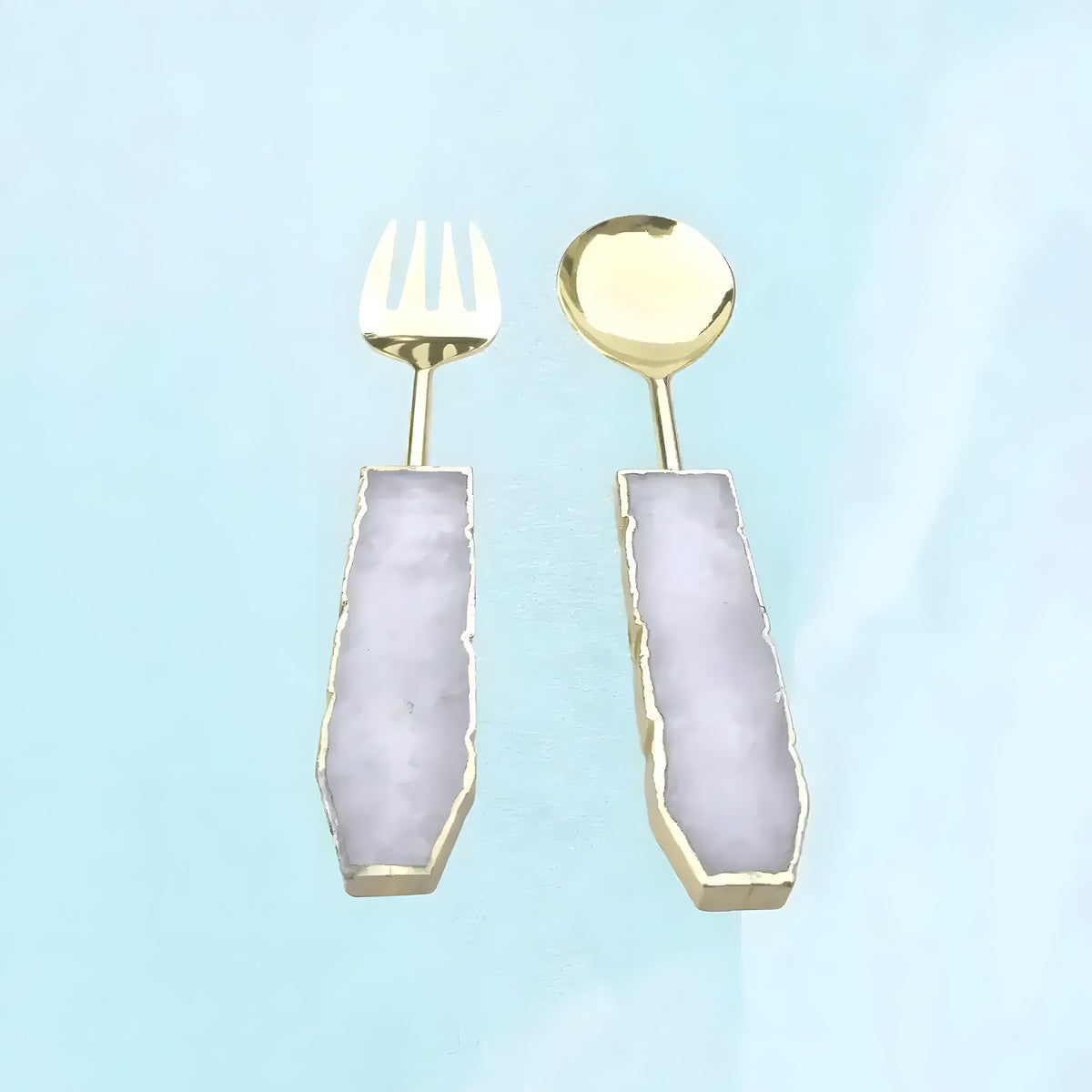 Rose quartz salad server set, gold fork and spoon with pale lavender-pink quartz handles in gold trim, front on aqua background