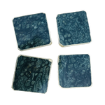 Kambaba jasper coaster set of 4, dark blue-green square stone coasters with orbicular patterns and silver-edged rims, overhead view