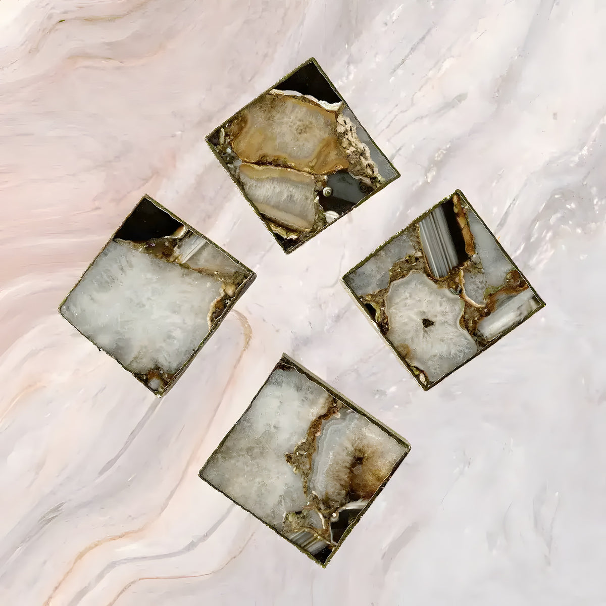 Brown-white composite agate coaster set of 4 in pinwheel layout on pink marble, square with grey composite and agate center