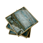 Stack of four blue-green composite agate coasters at angle showing teal-blue and grey-brown mineral veining, gold edge.