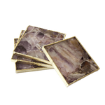 Set of four amethyst agate coasters fanned and stacked — purple-mauve crystalline stone slabs with white veining in gold rectangular frames