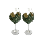 Two dark green quartz wine glasses with crushed green crystal chip bowls and jagged gold rim trim on clear glass stems