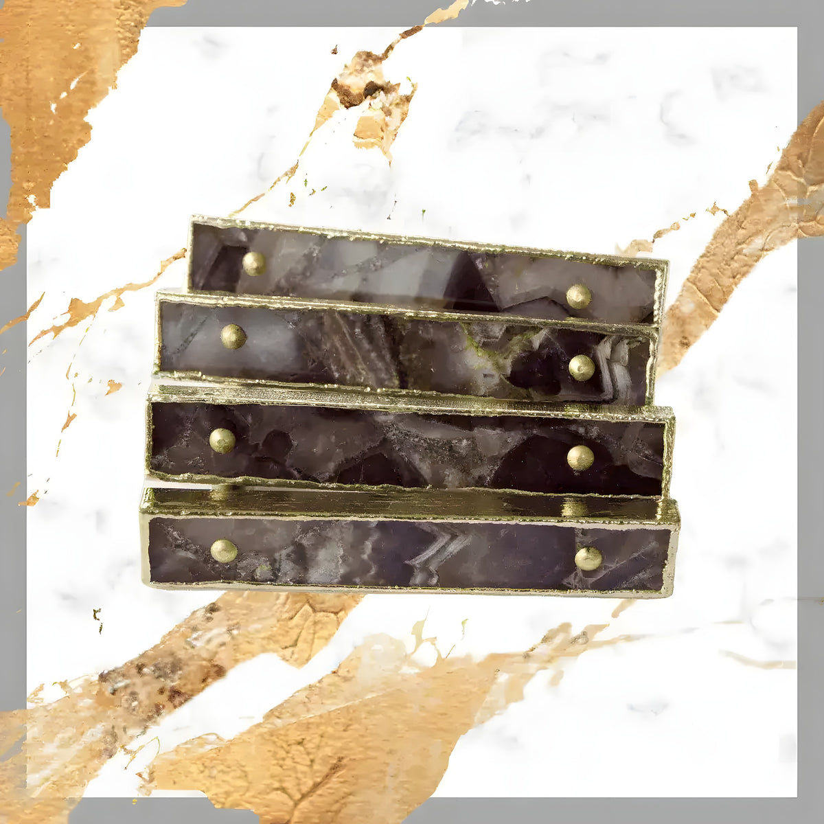 Four amethyst agate pull handles fanned on white-gold marble, deep purple-grey banded stone, gold-tone edge frames, gold dome studs