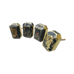 Four dark charcoal agate faceted drawer pulls in gold rectangular settings, arranged in a row on white background