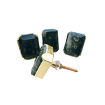 Four kambaba jasper cabinet knobs with dark green fossil-patterned stone in gold rectangular bezels, one showing screw hardware