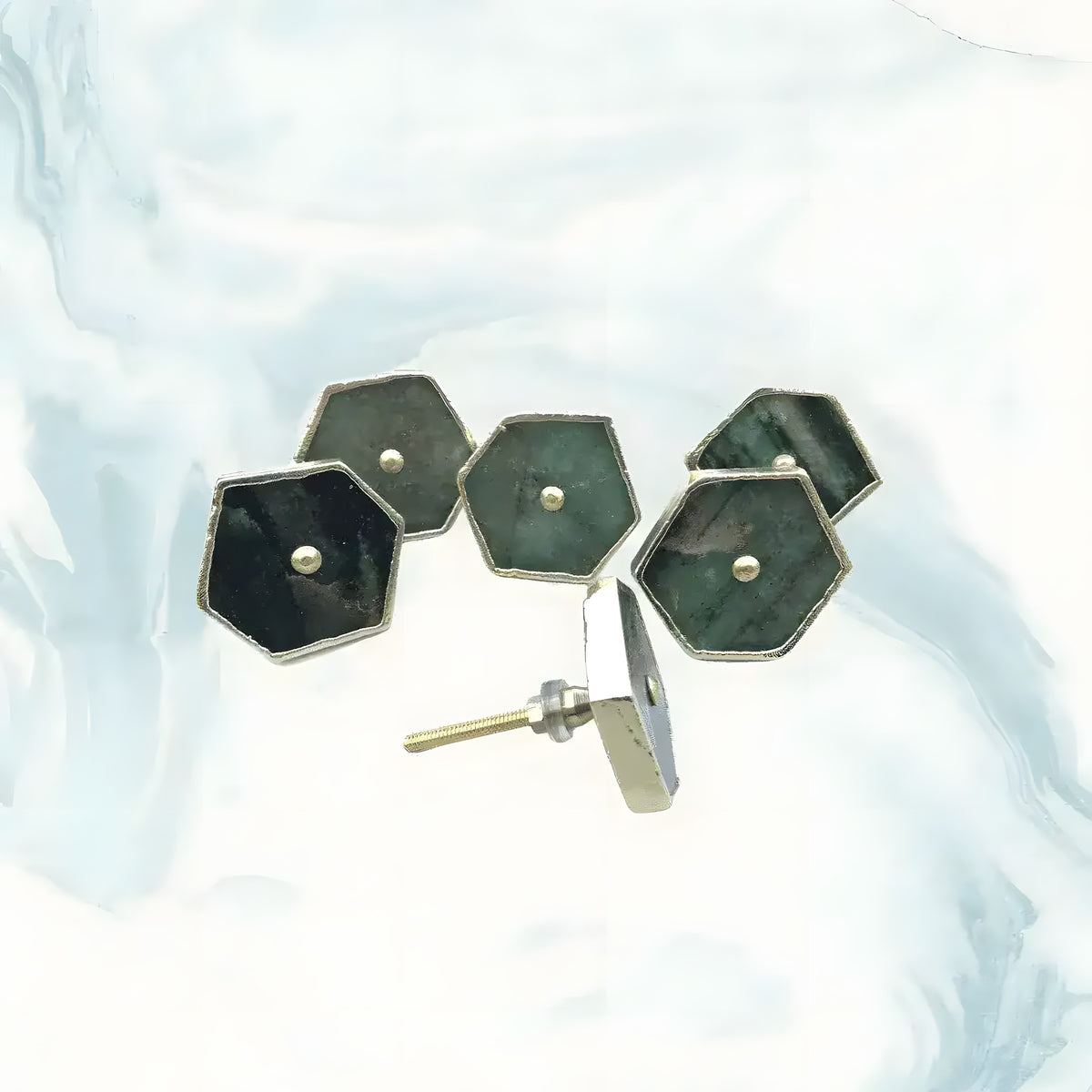Overhead view of four sage green agate hexagonal pull handles showing back side with mounting screws on light fabric