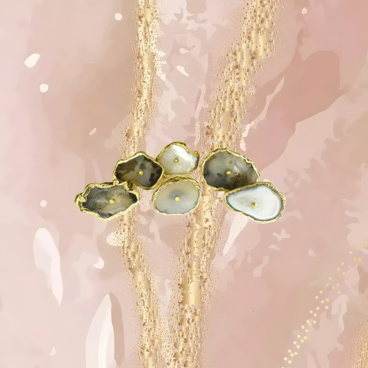 Six natural gray agate cabinet pulls with organic shapes on blush pink watercolor background, gold studs and edging.