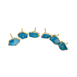 Six sky-blue quartz oval knobs arranged in a wide arc showing smooth polished faces with gold rims and center studs
