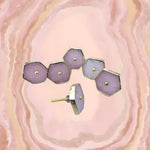 Six rose quartz hexagonal cabinet pulls in lavender-pink tones, on a swirling pink agate background, one showing the screw.