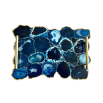 Top-down view of large blue agate serving tray with brass handles showing mosaic of navy and ice-blue agate slices with silvery mineral fill