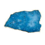 Organic-shaped large blue agate cheese platter with vibrant blue stone surface, circular ring markings, gold-painted raw edge