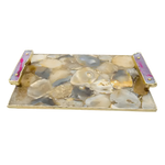 3/4 angled view of brown plated agate serving tray with beige and grey round agate slices, gold frame, two pink onyx handles